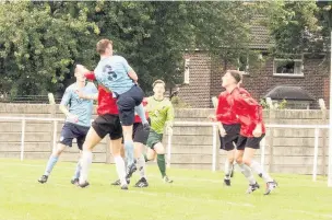  ?? Paul Watson ?? Town defender Joe Heath rises for a header against Abbey Hey.