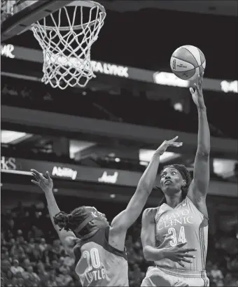  ?? AARON LAVINSKY/STAR TRIBUNE VIA AP, FILE ?? Minnesota center Sylvia Fowles, right, shoots over Atlanta’s Sancho Lyttle on Aug. 3 in St. Paul, Minn. Fowles is averaging a double-double for the Lynx, who have a league-best 21-3 record.