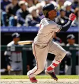  ?? MATTHEW STOCKMAN / GETTY IMAGES ?? The Braves’ Ozzie Albies hits an RBI double in the fifth inning against the Rockies at Coors Field on Sunday in Denver. Albies also hit one of the Braves’ three homers in their 4-0 victory.