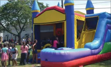  ?? KEITH REYNOLDS — THE MORNING JOURNAL ?? Children wait in line to climb into a bouncy house at the fourth annual Love, Peace and Soul Fest Aug. 19 at Westview Terrace in Lorain.