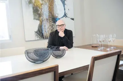  ?? BENOIT DESJARDINS. ?? Jean-Claude Poitras, Quebec artist and designer, sits at one of his 19 favourite pieces of Quebec furniture, on display this weekend. Visitors to the Open House can vote for their favourite piece of furniture or model suite and win prizes.
