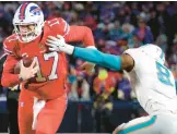  ?? TIMOTHY T LUDWIG/GETTY ?? The Dolphins will have to limit Bills quarterbac­k Josh Allen, left, from running all over their defense, as he did in their last meeting on Dec. 17.