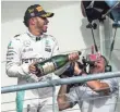  ?? JEROME MIRON, USA TODAY SPORTS ?? Lewis Hamilton sprays champagne on fans Sunday after winning the U.S. Grand Prix.