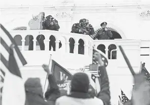  ?? JOHN MINCHILLO/ AP ?? Supporters loyal to President Donald Trump clash with authoritie­s before breaching the Capitol on Jan. 6.