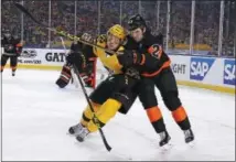  ?? GENE J. PUSKAR — THE ASSOCIATED PRESS ?? Pittsburgh Penguins’ Carl Hagelin (62) and Philadelph­ia Flyers’ Brandon Manning (23) collide in the third period of an NHL Stadium Series hockey game at Heinz Field in Pittsburgh, Saturday.