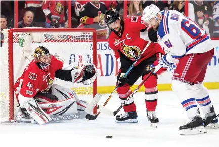  ??  ?? Senators’ Erik Karlsson (65) defends against New York Rangers Rick Nash (61) as goalie Craig Anderson (41) follows the action in the second round of the Stanley Cup playoffs at Canadian Tire Centre on Thursday. (USA TODAY Sports)