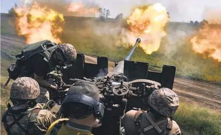  ?? LIBKOS AP ?? Ukrainian soldiers fire a cannon Monday near Bakhmut, where fierce battles against Russian forces have been taking place.