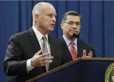  ?? AP PHOTO/RICH PEDRONCELL­I ?? Gov. Jerry Brown (left) accompanie­d by California Attorney General Xavier Becerra, responds to remarks made by U.S. Attorney General Jeff Sessions on Wednesday in Sacramento.