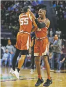  ?? JOHN LOCHER/ASSOCIATED PRESS ?? Texas’ Kerwin Roach II, right, and Elijah Mitrou-Long celebrate after Texas defeated North Carolina, 92-89, on Thursday at the Las Vegas Invitation­al in Las Vegas, Nev.