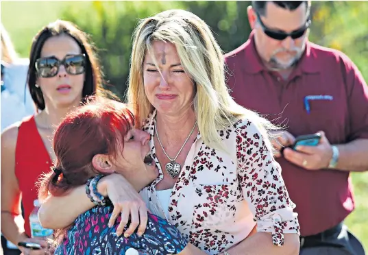  ??  ?? Main: parents wait for news after the mass a shooting at Marjory Stoneman Douglas High School in Parkland, Florida. Above, from top, the suspect is held, before being taken away in an ambulance; pupils are led to safety