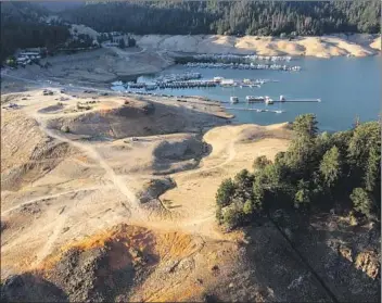  ?? Brian van der Brug Los Angeles Times ?? BOATS at a marina in Lake Shasta sit hundreds of feet from their usual spots because of low water levels.