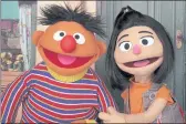  ?? NOREEN NASIR — THE ASSOCIATED PRESS ?? Ernie, from “Sesame Street,” introduces Ji-Young, the show’s first Asian American muppet.