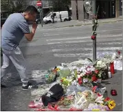  ?? ANDREW MEDICHINI — THE ASSOCIATED PRESS ?? A man wipes his eyes after leaving flowers at the spot where policeman Mario Cerciello Rega was stabbed to death.