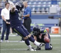  ?? Elaine Thompson ?? Seahawks kicker Sebastian Janikowski, shown with holder Jon Ryan on Thursday in Seattle, spent 18 seasons with the Raiders before departing in the spring.The Associated Press