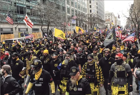  ?? Stephanie Keith / Getty Images ?? Members of the Proud Boys march toward Freedom Plaza during a protest on Dec. 12 in Washington, D.C. Thousands of protesters who refuse to accept that President-elect Joe Biden won the election rallied ahead of the Electoral College vote to make Trump’s 306-to-232 loss official.