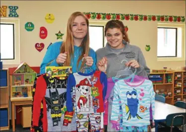  ?? SUBMITTED ?? Brooke Bird (North Ridgeville) and Hailey Blackburn (Keystone) smile with some PJs that were collected during their pajama drive.