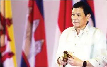  ?? YE AUNG THU/AFP ?? Philippine President Rodrigo Duterte holds the gavel during the closing ceremony of the ASEAN Summit and handover of the ASEAN chairmansh­ip to the Philippine­s in Vientiane on September 8.