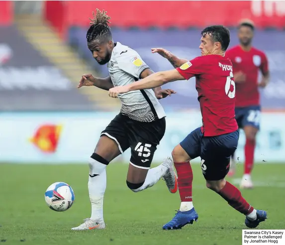  ??  ?? Swansea City’s Kasey Palmer is challenged by Jonathan Hogg