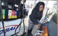  ?? Hearst Connecticu­t Media file photo ?? Stamford's Lettresha Nelson fills up at a Global gas station in Norwalk in 2016.