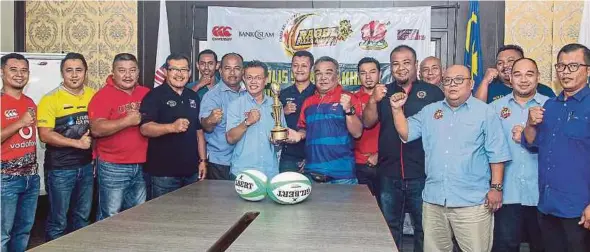  ??  ?? Malaysia Rugby Tournament director Fahmy Jalil (centre in dark blue T-shirt) with state team managers at the Agong’s Cup meeting in Kuala Lumpur yesterday.