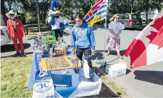  ?? DARREN STONE, TIMES COLONIST ?? Simran Cheema enjoys a surprise pop-up awards ceremony after teachers from Reynolds Secondary turned up at her house on Thursday.