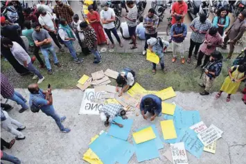  ??  ?? Demonstrat­ors prepare placards before attending a protest march against a new citizenshi­p law in Kochi. — Reuters