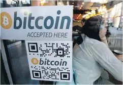  ?? JONATHAN HAYWARD / THE CANADIAN PRESS FILES ?? Bitcoin has not yet taken off among mainstream consumers and the introducti­on of a competing token will make it even more complex and confusing to get started.
