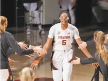  ?? John Todd / ISI Photos / Getty Getty Images ?? Belibi, with her distinctiv­e eyewear, can see the impact her dunks have on young players who then believe in themselves.