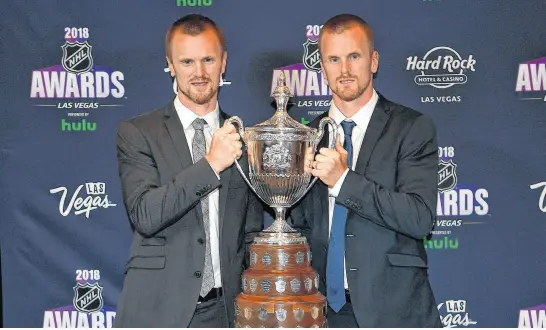  ?? STEPHEN R. SYLVANIE • USA TODAY SPORTS ?? Henrik Sedin and Daniel Sedin are pictured June 20, 2018, with the King Clancy award during the 2018 NHL Awards at Hard Rock Hotel and Casino in Las Vegas, Nev.