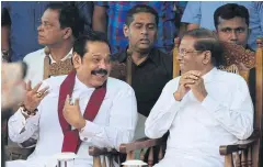  ??  ?? Former president and newly appointed prime minister Mahinda Rajapaksa (left) speaks with Sri Lankan President Maithripal­a Sirisena at a rally in Colombo last week.