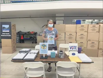  ?? COURTESY OF BRANDYWRIG­HT ?? Cindi Wilde of the Butte County Clerk-Recorders office helps set up the election table at the Local Assistance Center for North Complex West Zone fire victims. Along with voter assistance, the center is open to help direct fire victims to different types of aid based on their needs and available resources.