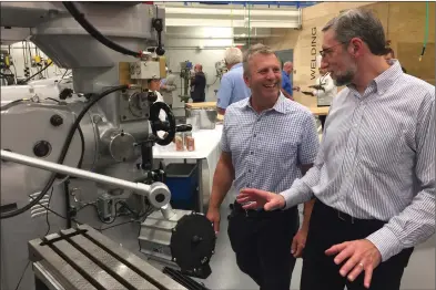  ?? Photos by Jonathan Bissonette ?? Mike Viveiros (left) and Ed Cifune (right) of DBVW Architects observe the technology inside the Center for Advanced Manufactur­ing at Davies Technical High School on Friday.