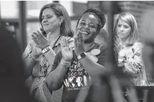  ??  ?? Tanya Dawson, from left, La’Kesha Vaughn and Mandy Benedix applaud TEA Commission­er Mike Morath in Pearland. Scores were judged for the first time on a new accountabi­lity system.