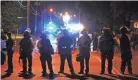  ?? / THE COMMERCIAL APPEAL BRAD VEST ?? Memphis Police officers monitor the scene of unrest following shooting that involved U.S. Marshals that resulted in the death of Brandon Webber in Frayser on June 12.