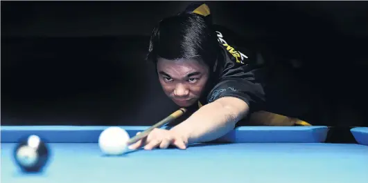  ?? PHOTO: GREGOR RICHARDSON ?? You are going down . . . Dunedin 8ball player Brendan Ng lines up the black during a practice session at Bowey’s Pool Lounge yesterday.