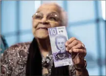  ?? Canadian Press file photo ?? Wanda Robson, sister of Viola Desmond, holds the new $10 banknote featuring Desmond during a press conference March 8, 2018, in Halifax.