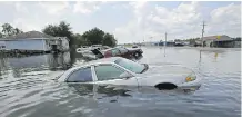  ?? GERALD HERBERT/THE ASSOCIATED PRESS ?? Flooded cars sit alongside a roadway in the aftermath of hurricane Harvey, in Port Arthur, Texas.