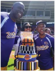  ?? REGAN COMMUNICAT­IONS PHOTO ?? Magic Johnson, wife Cookie, and childhood pal Jeffrey Osbourne pose with a Lakers-themed birthday cake for Johnson, who turns 56 next week, at the Jeffrey Osborne Celebrity Softball Classic in Pawtucket, R.I.