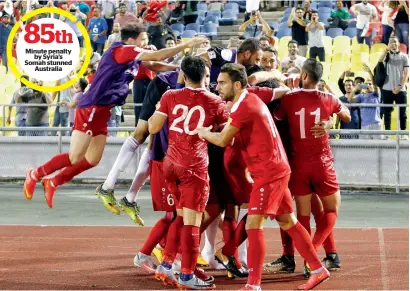  ?? — Reuters ?? Syrian players celebrate after Omar Al Somah converted a penalty kick against Australia in the playoff on Thursday.