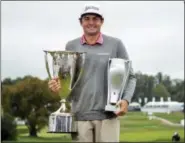  ?? CHRIS SZAGOLA — THE ASSOCIATED PRESS ?? Keegan Bradley poses with the trophies following the BMW Championsh­ip golf tournament at the Aronimink Golf Club, Monday in Newtown Square, Pa