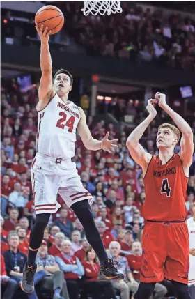  ?? ASSOCIATED PRESS ?? Wisconsin’s Bronson Koenig shoots past Maryland’s Kevin Huerter during the second half of Sunday’s game at the Kohl Center in Madison. Koenig scored nine points after halftime.