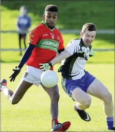  ??  ?? Rathnew’s Jonah Graham is challenged by AGB’s Stephen Hurley.