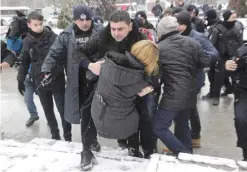  ??  ?? ANKARA: Riot police detain a protester as dozens of demonstrat­ors gathered yesterday in front of Turkey’s parliament to protest proposed amendments to the country’s constituti­on that would hand sweeping executive powers to President Recep Tayyip Erdogan’s largely ceremonial presidency. — AP