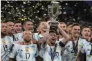  ?? ?? Lionel Messi lifts the trophy after Argentina won their interconti­nental match with Italy. Photograph: Frank Augstein/AP