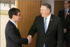  ?? POOL PHOTO VIA AP ?? U.S. Secretary of State Mike Pompeo, right, shakes hands with Japan’s Foreign Minister Taro Kono before a meeting in Tokyo Saturday.