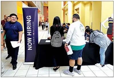  ?? AP/ALAN DIAZ ?? Job seekers gather at a job fair booth on Oct. 3 in the Dolphin Mall in Sweetwater, Fla. August job openings fell slightly to just under 6.1 million, the Labor Department said Wednesday, from 6.14 million in the previous month.