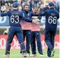  ??  ?? England's Adil Rashid (2nd L) celebrates with teammates after taking the wicket of Australia's Moises Henriques for 17. - AFP