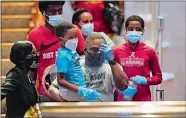  ?? DAVID J. PHILLIP, POOL/AP PHOTO ?? Mourners pass by the casket of George Floyd during a public visitation for Floyd at the Fountain of Praise church in Houston on Monday.