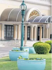  ?? THANARAK KHUNTON ?? New ceramic lotus pots are seen on the lawn of the Government House. Officials said the new pots have replaced older ones that leaked water, and they have been placed there to beautify the landscape. The pots were paid for by Prime Minister Prayut...