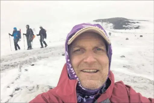  ??  ?? FIGHTER: Raymond Funnell on Mt Elbrus, and with his brother Jay. Funnell is climbing the highest mountains on each continent even though he is in remission from cancer.